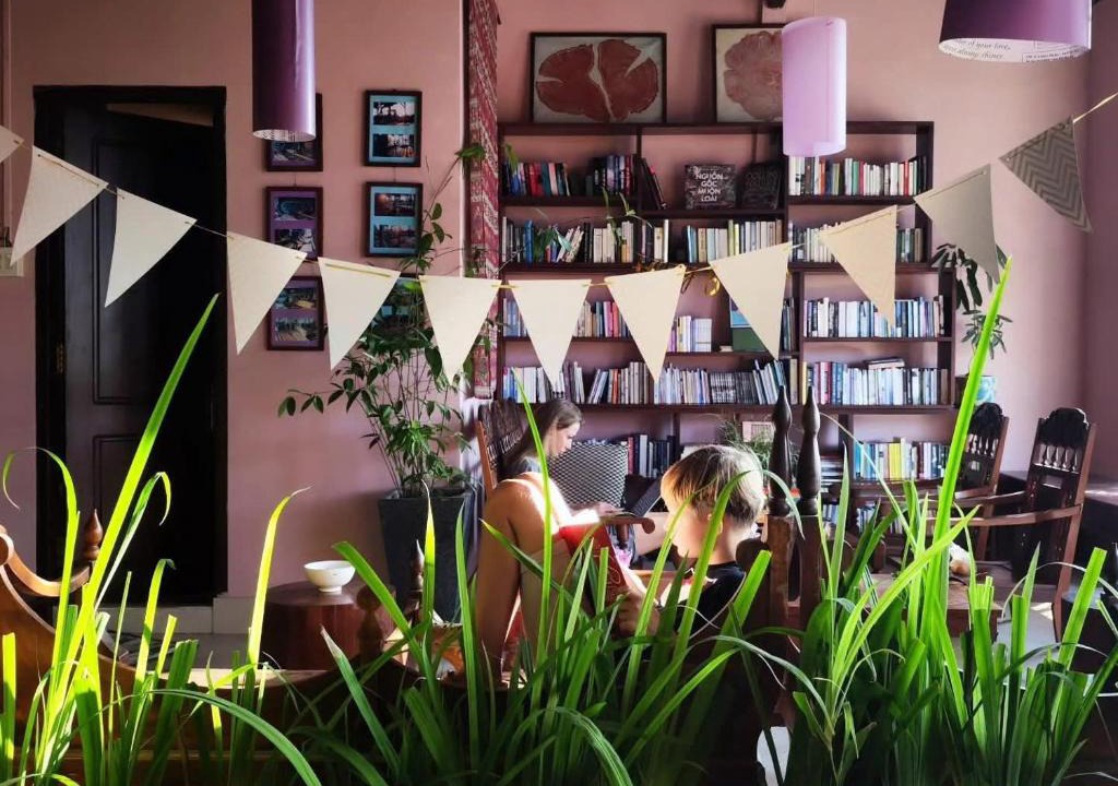 Can Tho House | Here Library - A wooden home by the river with a library