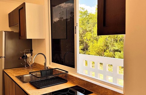 Tulum Condo | A Modern and cozy apartment in Ameli Tulum, surrounded by nature in Region 15. Enjoy the pool, peaceful common areas, and a stylish space designed for relaxation. Perfect for couples or travelers seeking comfort and a chic Tulum experience.
