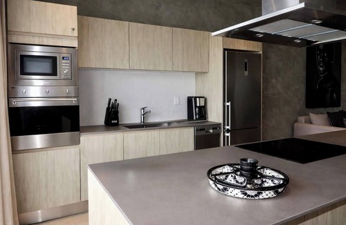 Tulum Condo | Enjoy Tulum from this comfortable 1BR apartment at TUK TULUM, ideal for up to 4 guests. It features a king bed, queen sofa bed, fully equipped kitchen, private balcony, and access to rooftop pools, paddle tennis courts, parking, and 24/7 security.