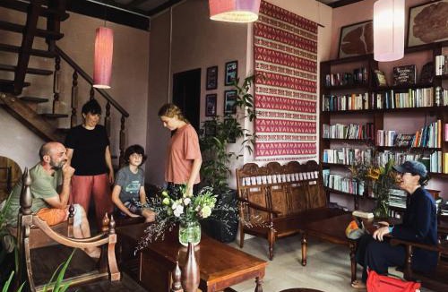 Can Tho House | Here Library - A wooden home by the river with a library