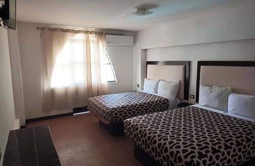 Mazatlan Hotel | Seaside Retreat: Comfortable Room with Clean Beds and Panoramic Ocean Views