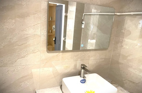 Nguyen Hue Walking Street Apartment | The Cafe Apartments building - Deluxe King room has a large window and a 70" TV