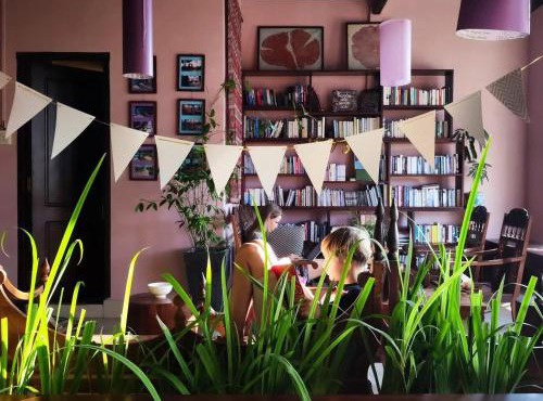 Here Library - A wooden home by the river with a library