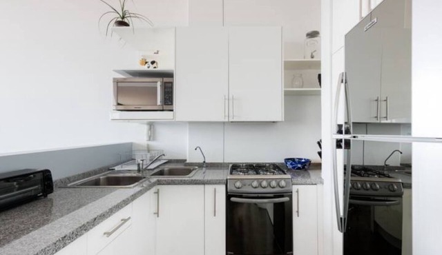 Loft in fifth floor with great views to green and the city and a roof garden too