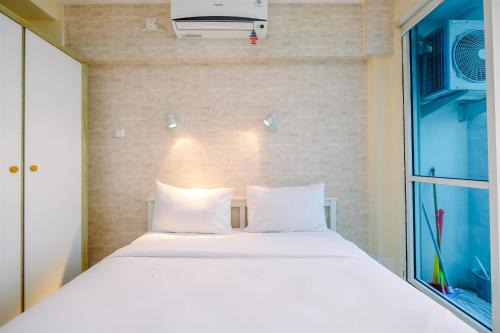 Kayu Putih Apartment | Minimalist Studio with Great City View at Tifolia Apartment By Travelio