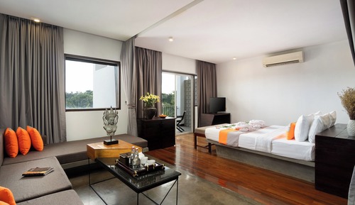 Junior King Suite City View with Balcony, Sofa Area, and Bathtub